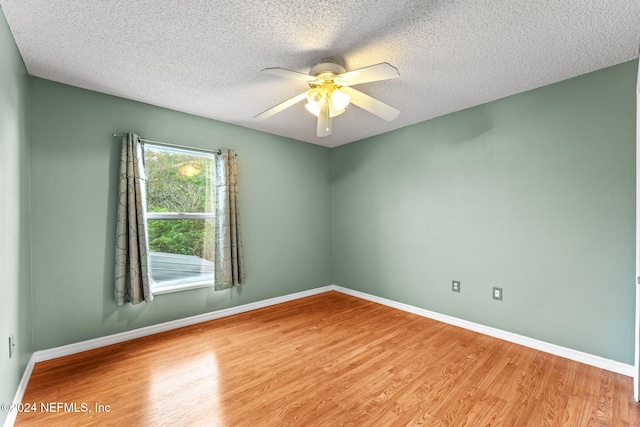 unfurnished room with ceiling fan, light hardwood / wood-style floors, and a textured ceiling