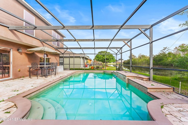 view of swimming pool featuring a patio area and a lanai