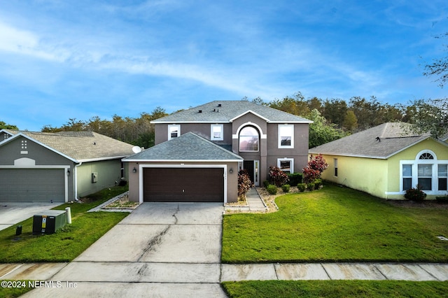 view of front property with a garage and a front lawn