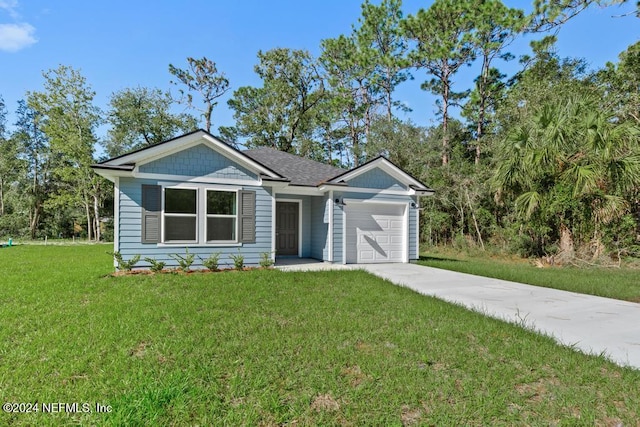 view of front of house featuring a garage and a front yard