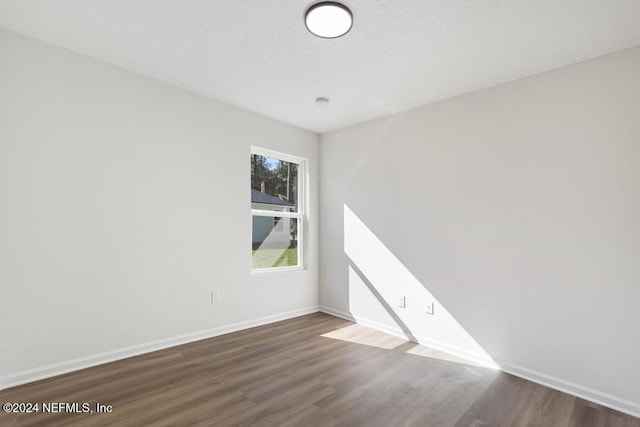 unfurnished room featuring hardwood / wood-style flooring