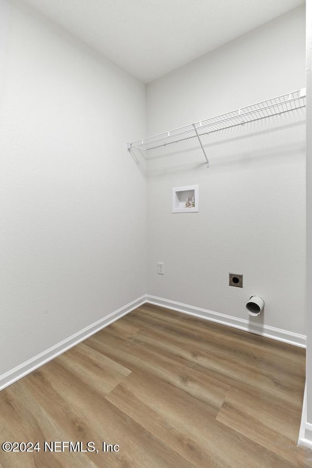 washroom with electric dryer hookup, washer hookup, and hardwood / wood-style flooring