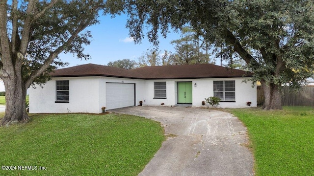 ranch-style house featuring a garage and a front yard