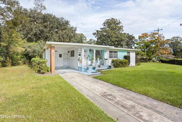 ranch-style house with a front yard and a carport