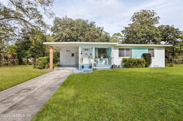 ranch-style home featuring a carport and a front yard