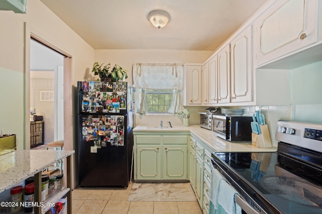 kitchen with white cabinets, green cabinets, and appliances with stainless steel finishes