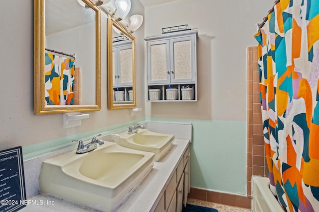 bathroom featuring shower / bath combo with shower curtain and vanity