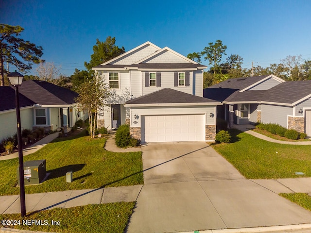 view of property with a garage and a front yard