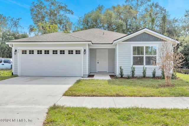 ranch-style home featuring a garage and a front yard