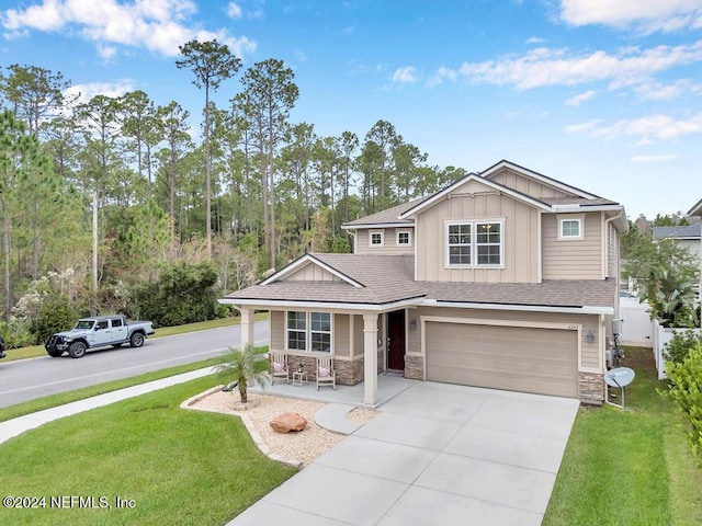 craftsman-style home featuring a front yard, a garage, and covered porch