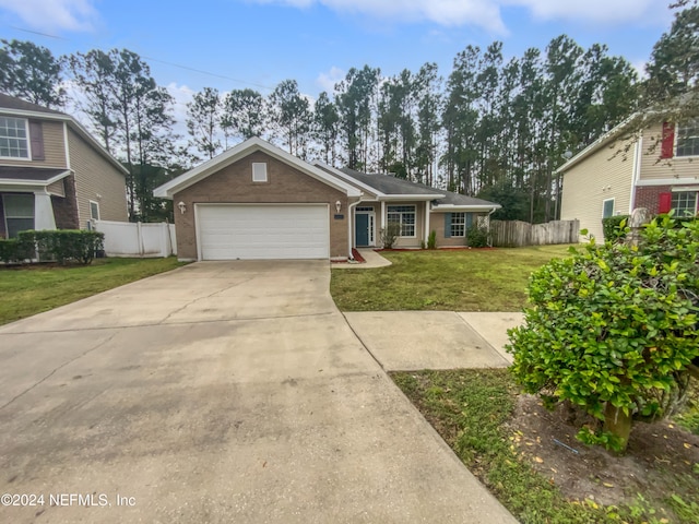 view of front of house with a front yard and a garage