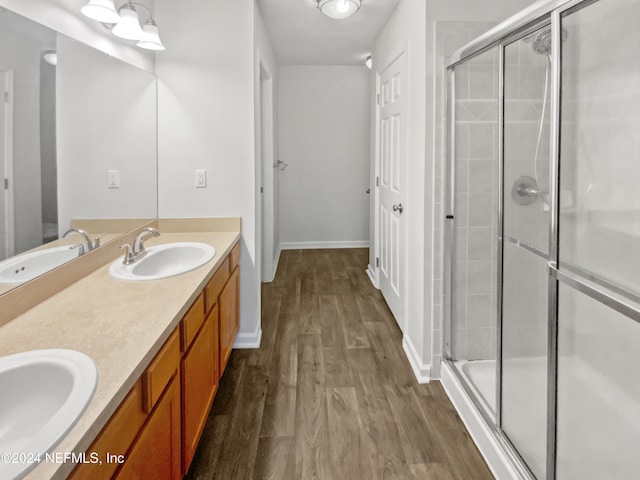 bathroom with vanity, hardwood / wood-style flooring, and walk in shower