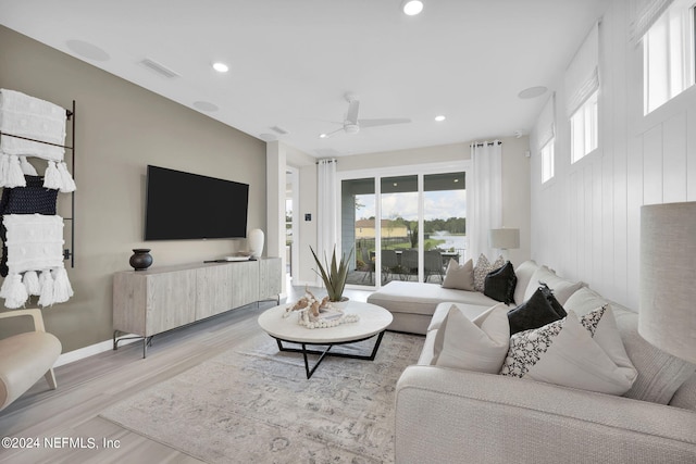 living room featuring ceiling fan and light wood-type flooring