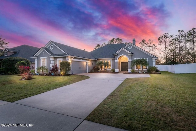 ranch-style house with a lawn and a garage