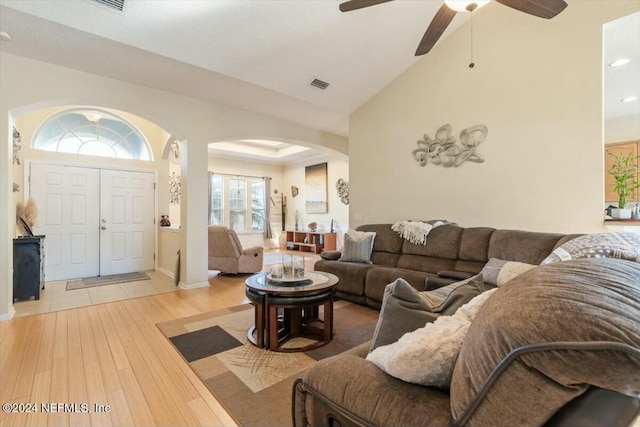 living room featuring hardwood / wood-style flooring, vaulted ceiling, and ceiling fan