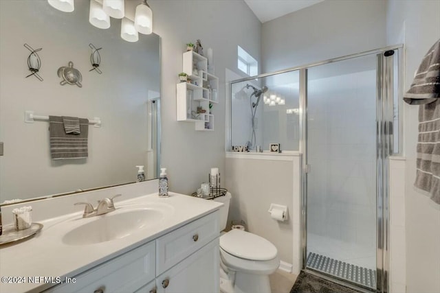 bathroom with toilet, vanity, and walk in shower