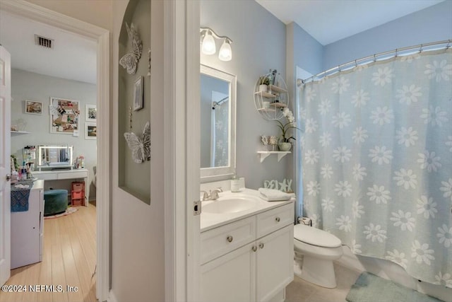 bathroom featuring hardwood / wood-style flooring, vanity, and toilet