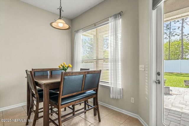 dining area featuring baseboards, a wealth of natural light, and light tile patterned floors