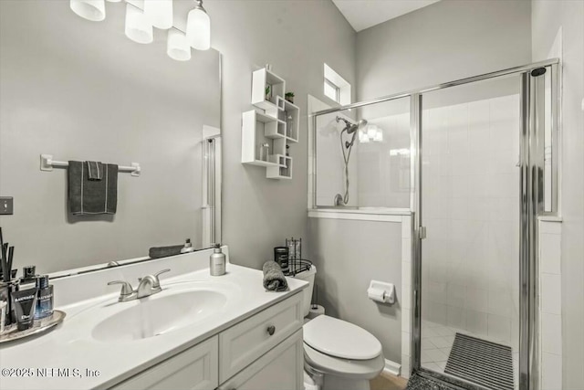 bathroom with a stall shower, visible vents, toilet, and vanity