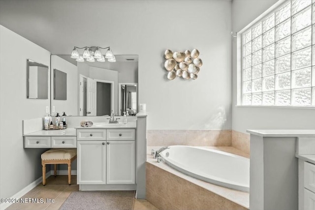 full bathroom featuring tile patterned floors, a bath, and vanity