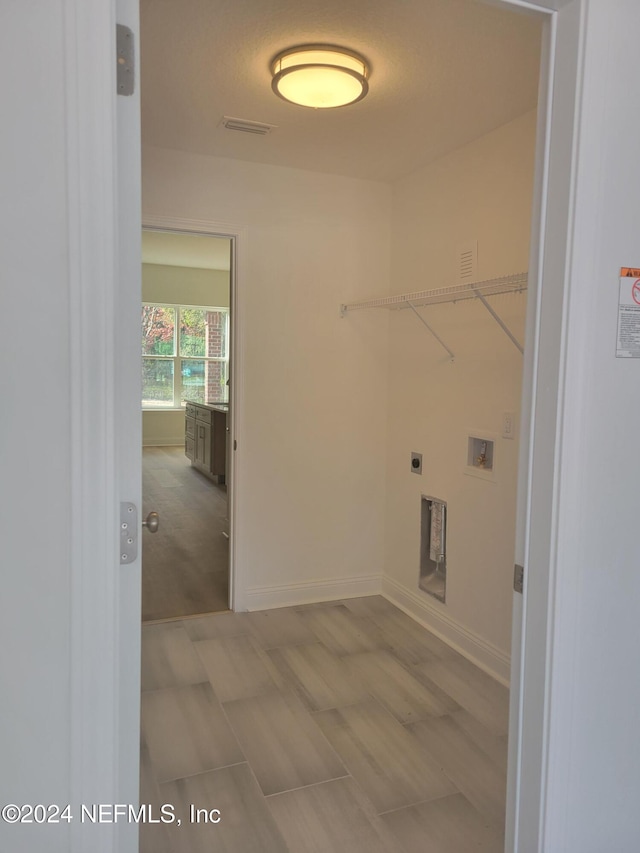 clothes washing area featuring electric dryer hookup and hookup for a washing machine