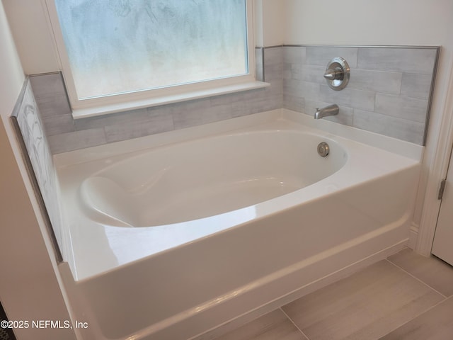full bathroom with a bath and tile patterned floors