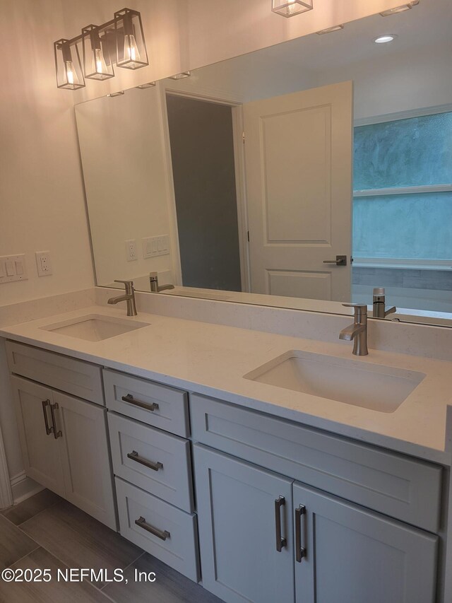 full bath with double vanity and a sink