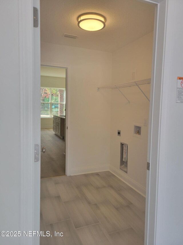 laundry room with laundry area, baseboards, visible vents, and washer hookup