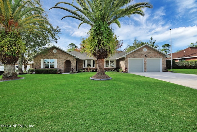 ranch-style house featuring a garage and a front lawn