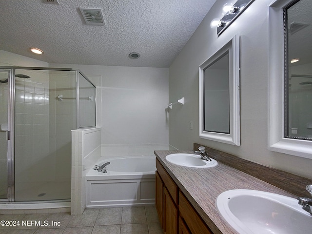 bathroom featuring tile patterned floors, separate shower and tub, vanity, and a textured ceiling