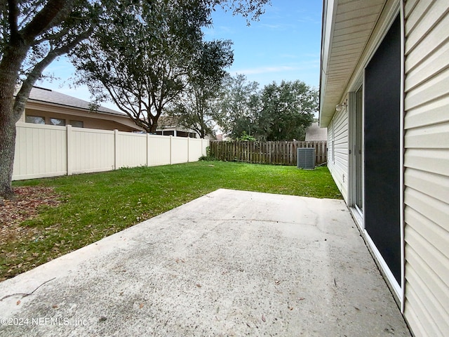 view of yard with cooling unit and a patio