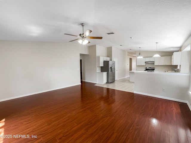 1421 Woodland View Dr, Fleming Island, FL 32003 - unfurnished living room with ceiling fan, a sink, baseboards, lofted ceiling, and light wood-type flooring
