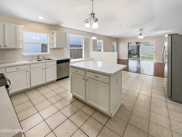 1421 Woodland View Dr, Fleming Island, FL 32003 - kitchen with a sink, light tile patterned floors, white cabinets, and stainless steel appliances