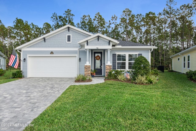 view of front of home featuring a garage and a front lawn