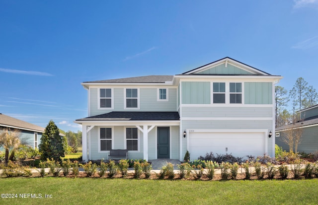 view of front facade with a garage and a front yard