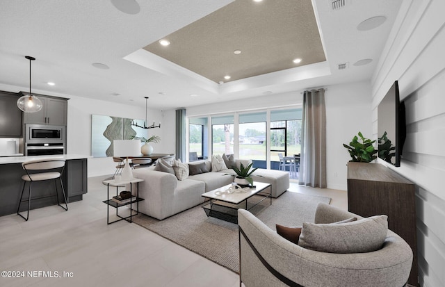 living room featuring a textured ceiling and a raised ceiling