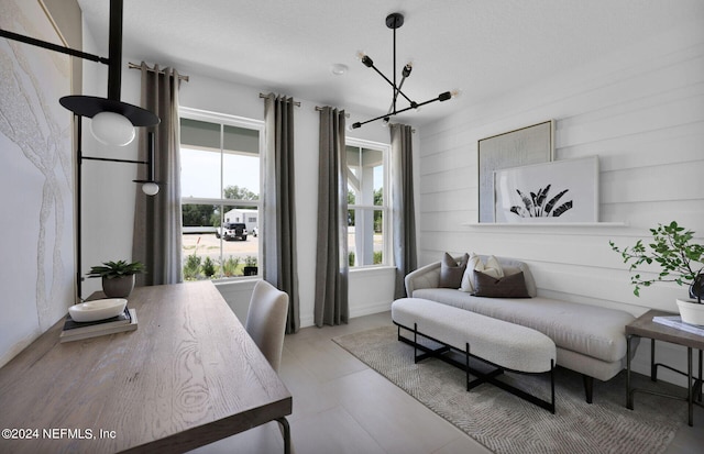 living room with wood walls, light tile patterned flooring, and a chandelier