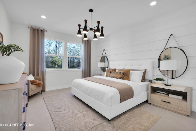 bedroom featuring a chandelier, light tile patterned floors, and wooden walls