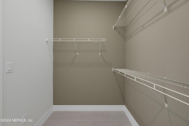 walk in closet featuring tile patterned flooring