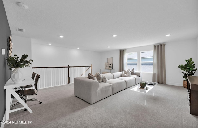 carpeted living room featuring a water view and a textured ceiling