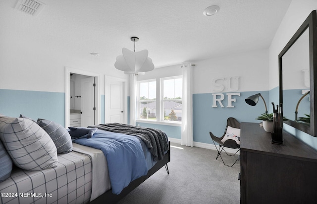 bedroom featuring light carpet and a textured ceiling