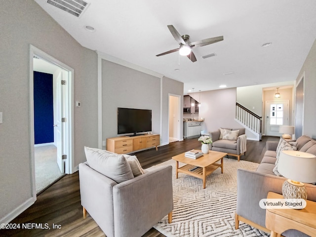 living room with hardwood / wood-style flooring, ceiling fan, and sink