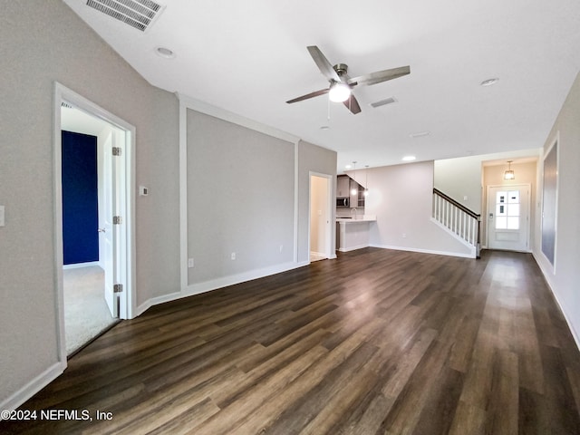 unfurnished living room featuring dark hardwood / wood-style floors and ceiling fan