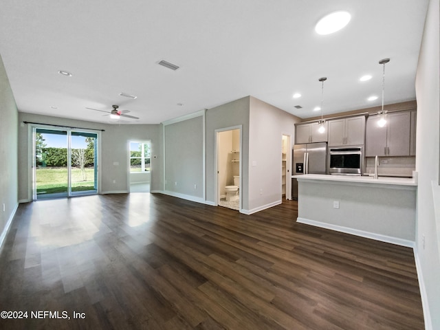 unfurnished living room with dark hardwood / wood-style floors and ceiling fan