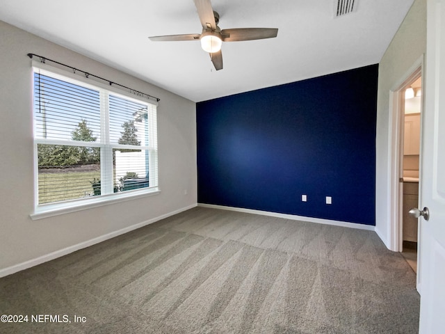 carpeted empty room with ceiling fan