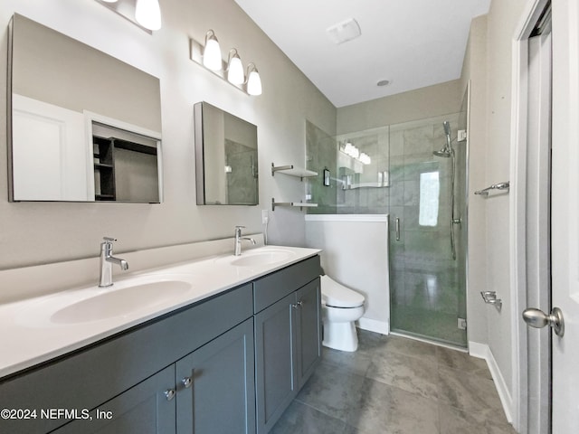 bathroom with tile patterned flooring, vanity, toilet, and walk in shower