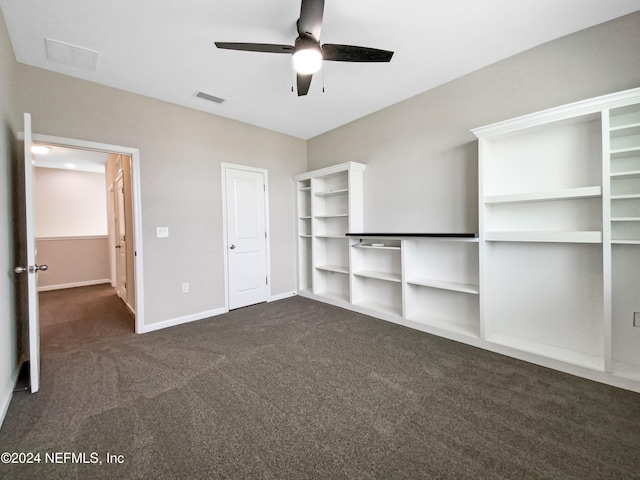 unfurnished bedroom featuring ceiling fan and dark carpet