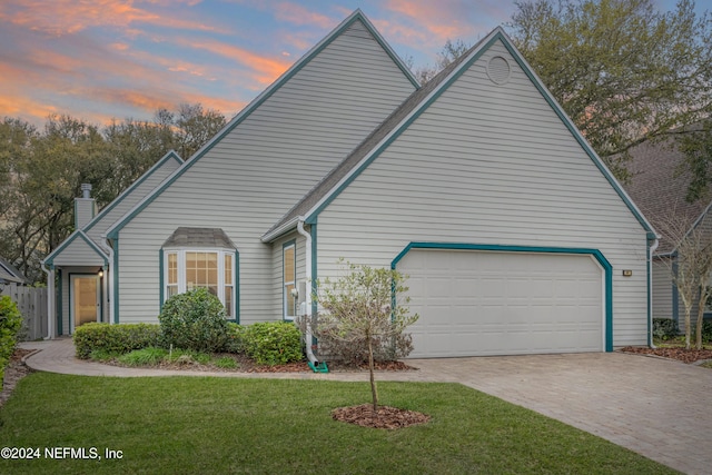 view of front of house with a lawn and a garage