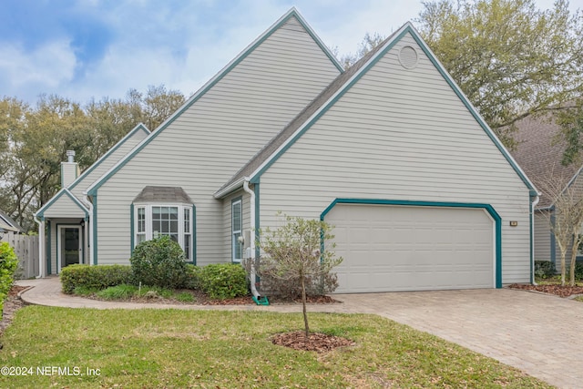 view of front of property with a front lawn and a garage