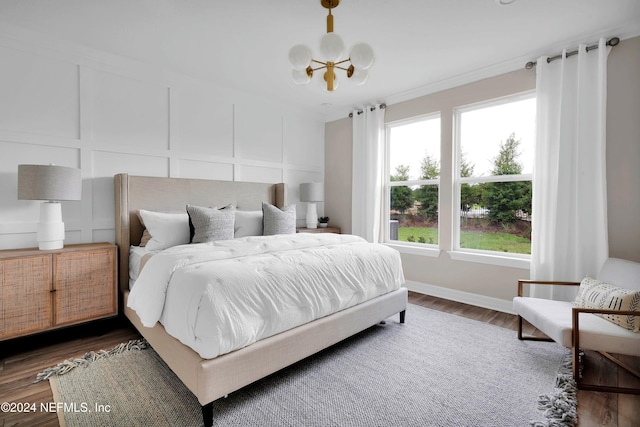 bedroom featuring dark wood-type flooring and an inviting chandelier